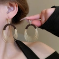 Close-up of gold layered hoop earrings with black thread wrapping for bohemian summer style - Gold Multi-layer Concentric Hoop Black Thread Earrings (11# Ear Hook)