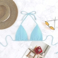 Flat lay detail of a light blue tie-front bikini top on marble background with beach props - Light Blue
