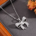 Close-up of silver bow pendant necklace with shimmering zircon stones and pearl detail - Silver Full Diamond Square Bowknot Necklace