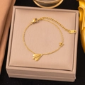 Delicate gold stainless steel bracelet featuring paper plane and star charms - Paper Airplane Bracelet / Gold