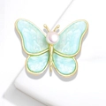 Detail of butterfly brooch with light blue pearlescent wings and central pearl decoration - YNCP5124 Green