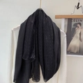 Detail of elegant black linen scarf with intricate lace patchwork texture and sheer mesh fabric - Black