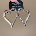 Detailed close-up of large heart-shaped S925 sterling silver earrings with mirror polish - Silver