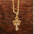 Golden crown key necklace with star details and white zircon stones on a wood surface - Crown Key Gold Color