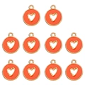 Détail de dix breloques cœur orange et doré pour la création de bijoux DIY - Orange
