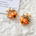 Macro shot of orange and white ceramic clownfish beads for DIY jewelry making - Price per Piece / Orange and White