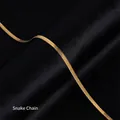 Elegant 18K gold-plated titanium steel blade chain necklace on black silk backdrop - Herringbone Chain / Gold