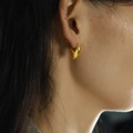 Minimalist 18K gold plated bean stud earring worn on model for a sleek aesthetic - Gold
