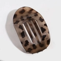 Flat oval hair claw clip featuring classic brown and black tortoiseshell leopard patterns - Translucent Khaki Leopard