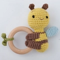 Handmade crochet bee baby rattle on natural wooden ring with green leaf detail - Hug Bee