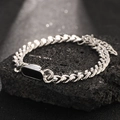 Silver cuban chain bracelet featuring a black rectangular charm on a dark rock - Bracelet / Black