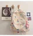 Detailansicht des beigen Rucksacks mit Bärenmuster und rosa Blumen-Plüschanhänger - Einzelne Tasche / Weißer Bär