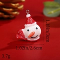 Detailed view of resin snowman pendant with red glitter hat, measuring 1.18 by 1.02 inches - Snowman with Sequin Hat and Scarf