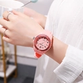 Close-up of pink children sport watch with silicone strap worn on a wrist - Pink