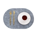 Oval grey faux leather placemat with linen texture shown with gold cutlery and cup - Oval / Oval Fog Blue