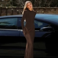 Detail of dark brown bodycon maxi dress with padded shoulders and long sleeves in outdoor light - XS / Brown