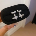 Detail of silver butterfly earring with three pearls and rhinestones on black velvet box - 17# Silver Needle Butterfly Zirconia Pearl Drop Earrings