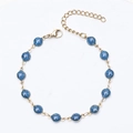 Detail of 18K gold plated chain with blue glitter beads and lobster clasp closure - Gold + Blue