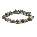 Detail of handmade bohemian bracelet featuring irregular natural colorful quartz stones - Moss Agate