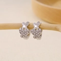 Macro shot of silver butterfly huggie earrings with cubic zirconia on a wooden branch - Half Diamond Butterfly Design Huggie-Silver