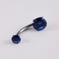 G23 titanium navel piercing with dark blue round zirconia and four-prong curved barbell - Sapphire Blue