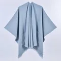 Light blue knit poncho cape featuring large front pockets and stylish fringed edges - Single Color with Pocket and Frayed Edge / Light Blue