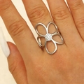 Silver hollow flower ring with textured stamen detail worn on a finger - Steel (DZ-382)