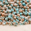 Lustrous blue and white round no-hole faux pearls on soft white plush surface - Gold Peacock Green