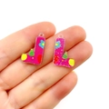 Close-up of pink acrylic boot charms with cartoon prints for DIY jewelry making - Letter L