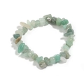 Macro shot of irregular light green natural agate stones on an elastic crystal bracelet - Green Aventurine