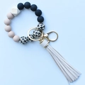 Detail of leopard print silicone beads with wooden accent and beige leather tassel - Khaki