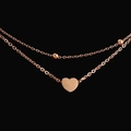 Detailed view of rose gold double-layer anklet with heart pendant and small beads - Rose Gold