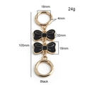 Detail of 105mm black enamel bow chain extender with golden spring ring clasps - Gold Buckle + Black Bow