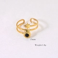 Detail of a 15mm double-layer gold ring with an eight-pointed star and dark round gemstone - Tiger Eye