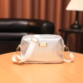 Silver wavy crossbody camera bag with wide white strap and gold-tone metal hardware - Folded Silver