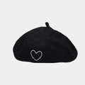Close-up of heart embroidery on a black wool beret showing fine texture and stitching - One Size / Black