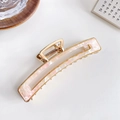 Elegant gold metal hair claw clip with pink marble acetate inlay on a white surface - Floral Pink