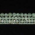 Natural light green prehnite round beads in four sizes displayed on black background - 6mm
