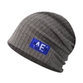 Detail of grey striped knit beanie featuring a blue AE logo label and drawstring toggle - Adjustable / AE Beige (Detachable Cord)