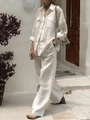 Detail of white linen-textured long-sleeve shirt and wide-leg trousers on model - S / White