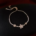 Detail of a gold floral bolero bracelet with sparkling cubic zirconia on a black texture - Flower / Gold