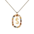 Detail of gold necklace pendant featuring letter S with colorful zircon stones inlay - S