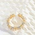 Detail of two-tone open ring with pavé-set zircons and criss-cross metal accents - Gold Silver Cross With White Zirconia