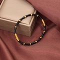 Detail of bamboo-style black enamel bracelet with gold-plated metal spacers on silk - Black