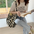 Lifestyle shot of large leopard print canvas tote bag held by a model near a window - Large Capacity Korean Tote Bag