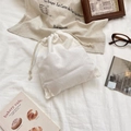 Detail of white cotton drawstring pouch with fine canvas texture on soft fabric background - M / Off White