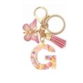 Detail of pink resin letter G keychain with heart sequins and butterfly charm - Letter G