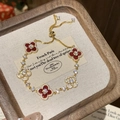 Elegant gold bracelet featuring four red clover charms with zircons in a wooden gift box - Gold/Red