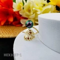 Detail of gold monstera leaf ring featuring a purple iridescent pearl on white pedestal - Iridescent Colorful Style (HEX1037-1)