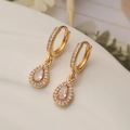 Luxurious gold teardrop earrings with pavé-set zircons and a central crystal stone - Gold